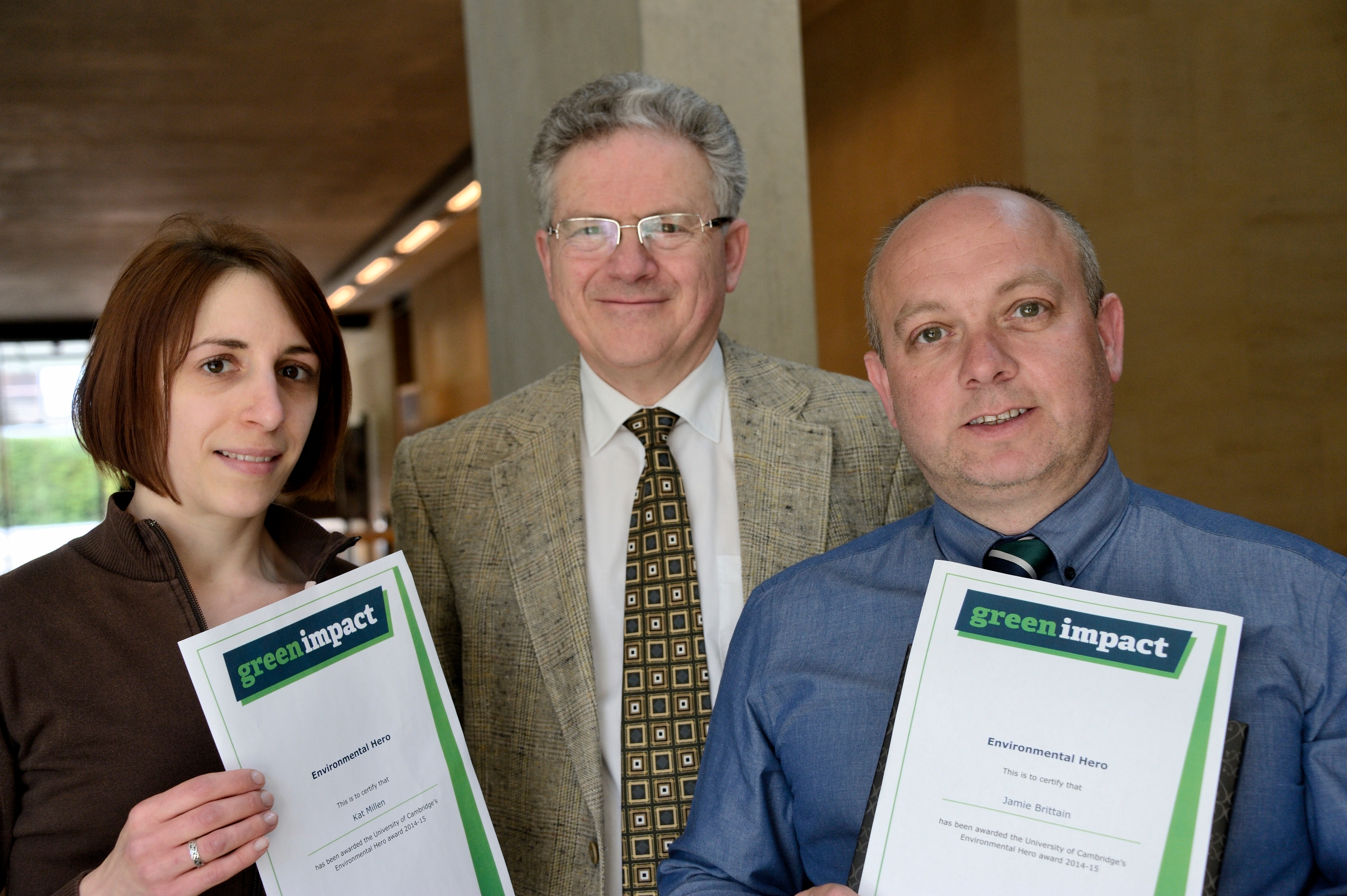 Kat Millen and Jamie Brittain collecting their Environmental Heroes award, with Professor Jeremy Sanders, Pro-Vice-Chancellor of Cambridge University
