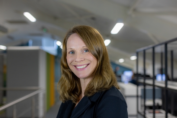 Headshot of Amanda Nolan, a smiling woman in a black blazer