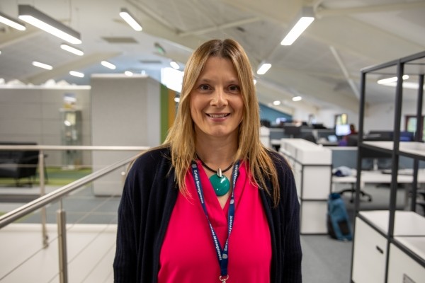 Headshot of Rachel Steward, a smiling woman in a pink top and black cardigan.