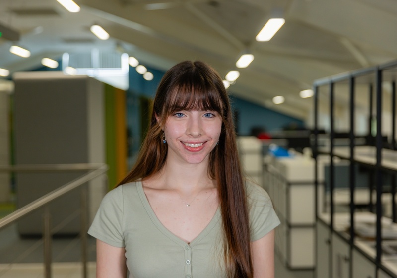 Headshot of Mica Carrey, a smiling woman with brown hair in a green top