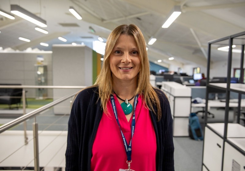 Headshot of Rachel Steward, a smiling woman with blonde hair in a pink top and black cardigan